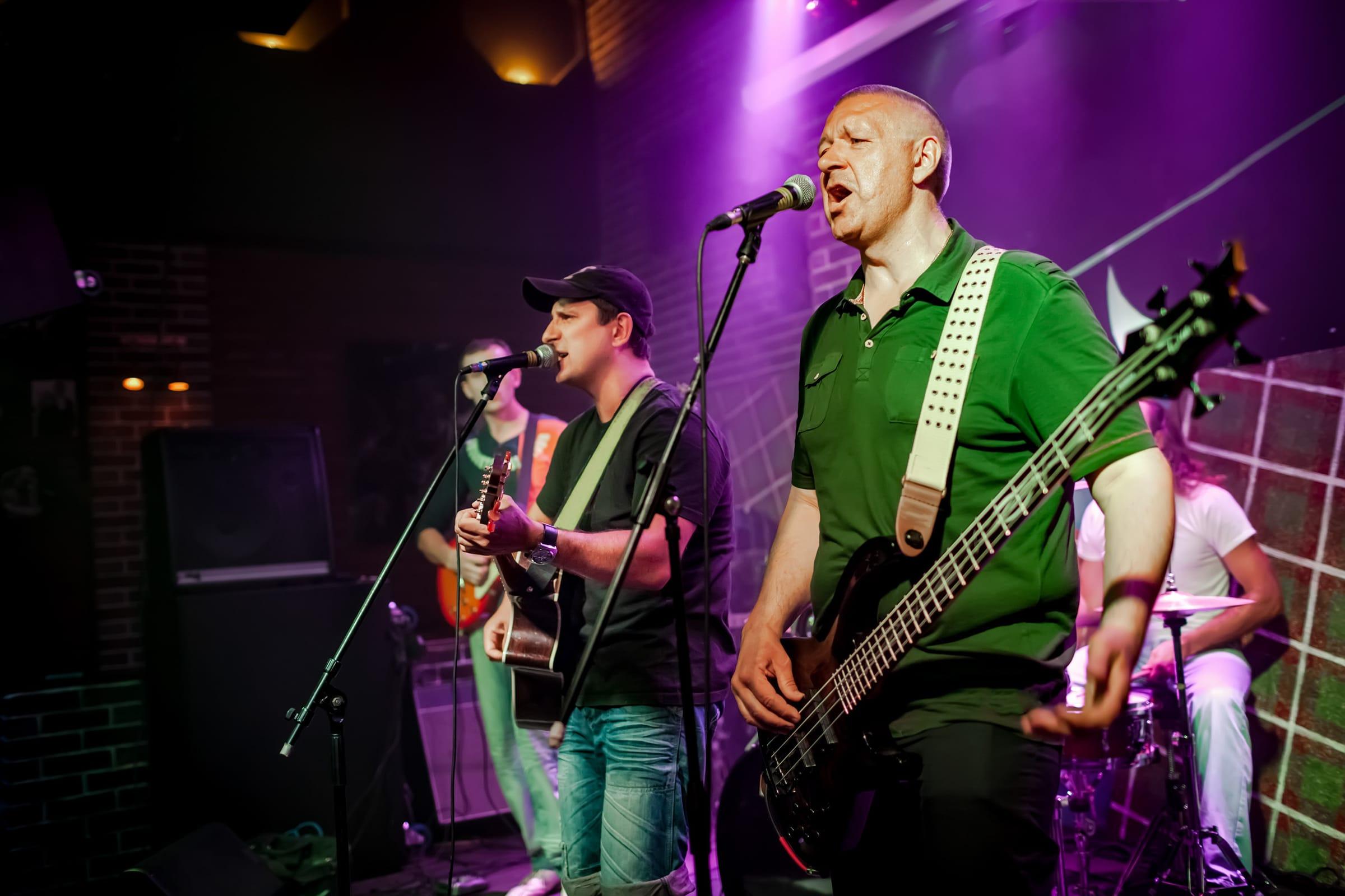 Live band performing under purple stage lights