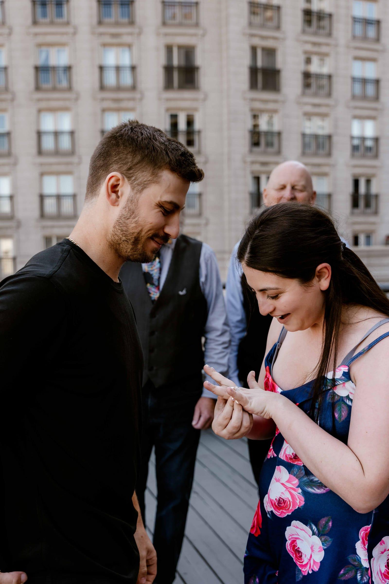 She said yes: woman admires her engagement ring after a surprise proposal