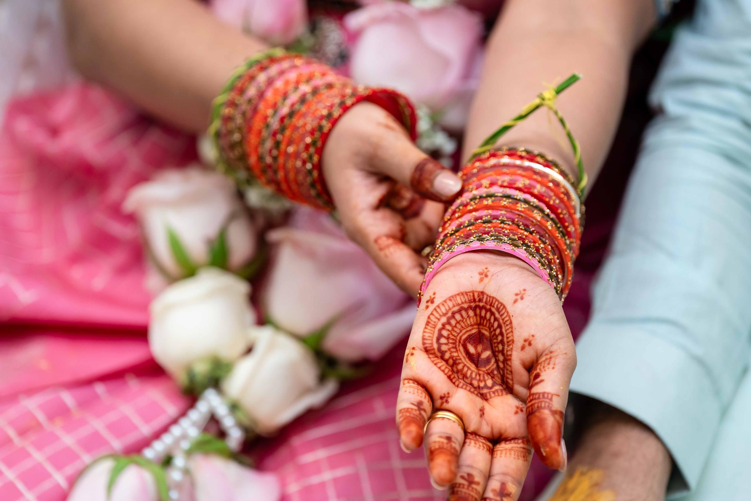 Henna hands and rose garland detail at a baby shower