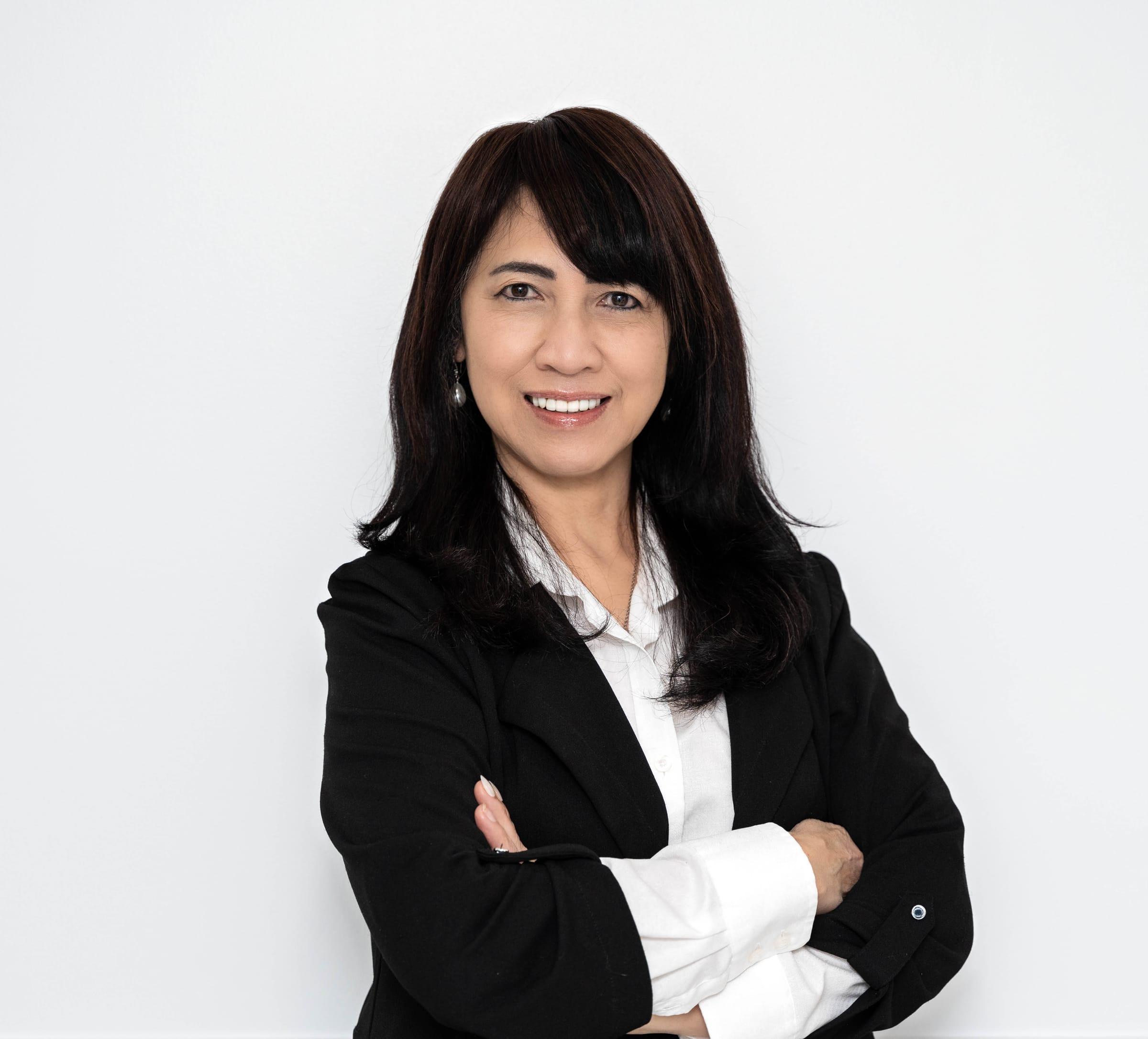 Confident professional portrait of a woman in a black blazer