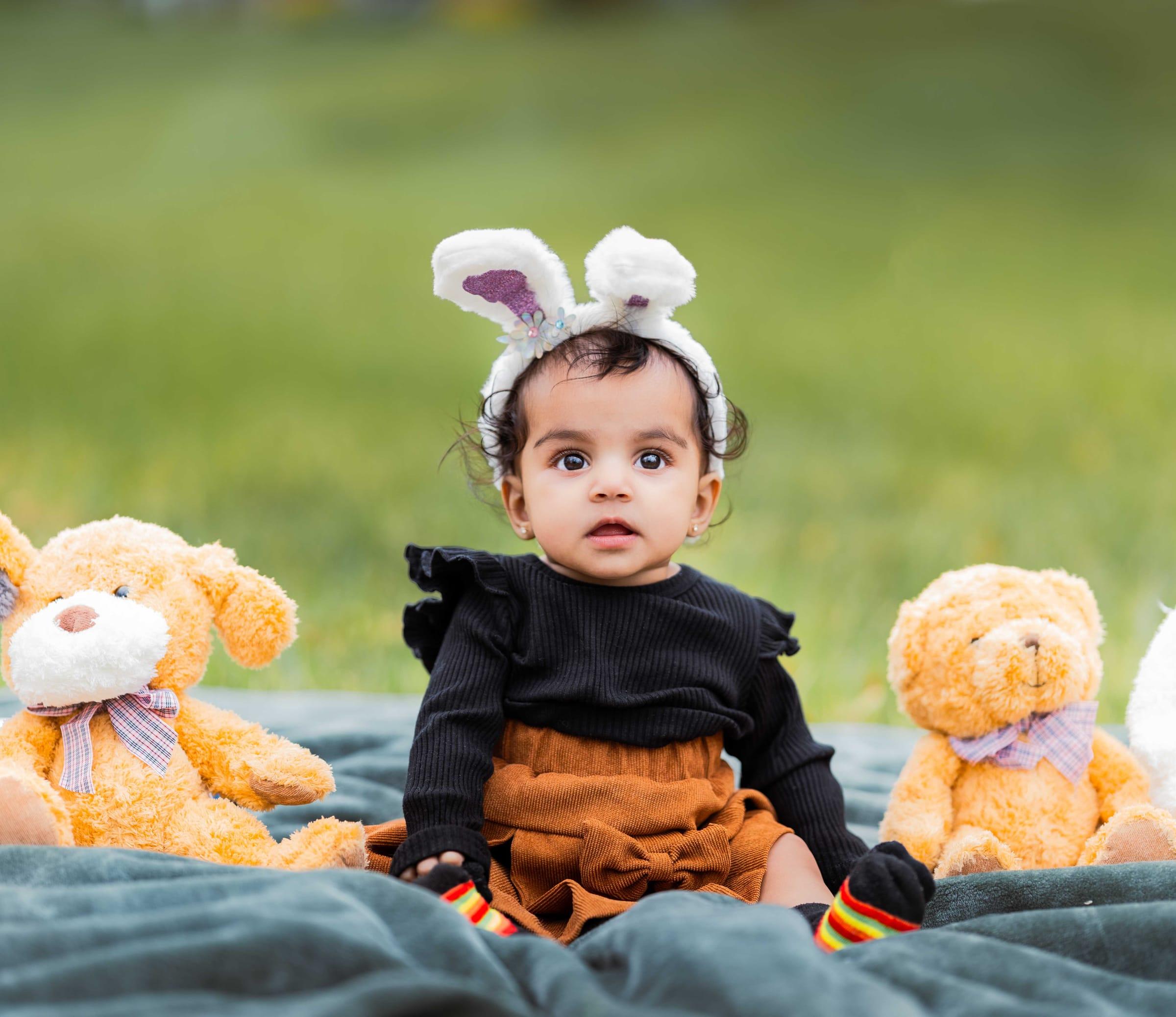 Baby in bunny ears with teddy bears, spring Easter mini session