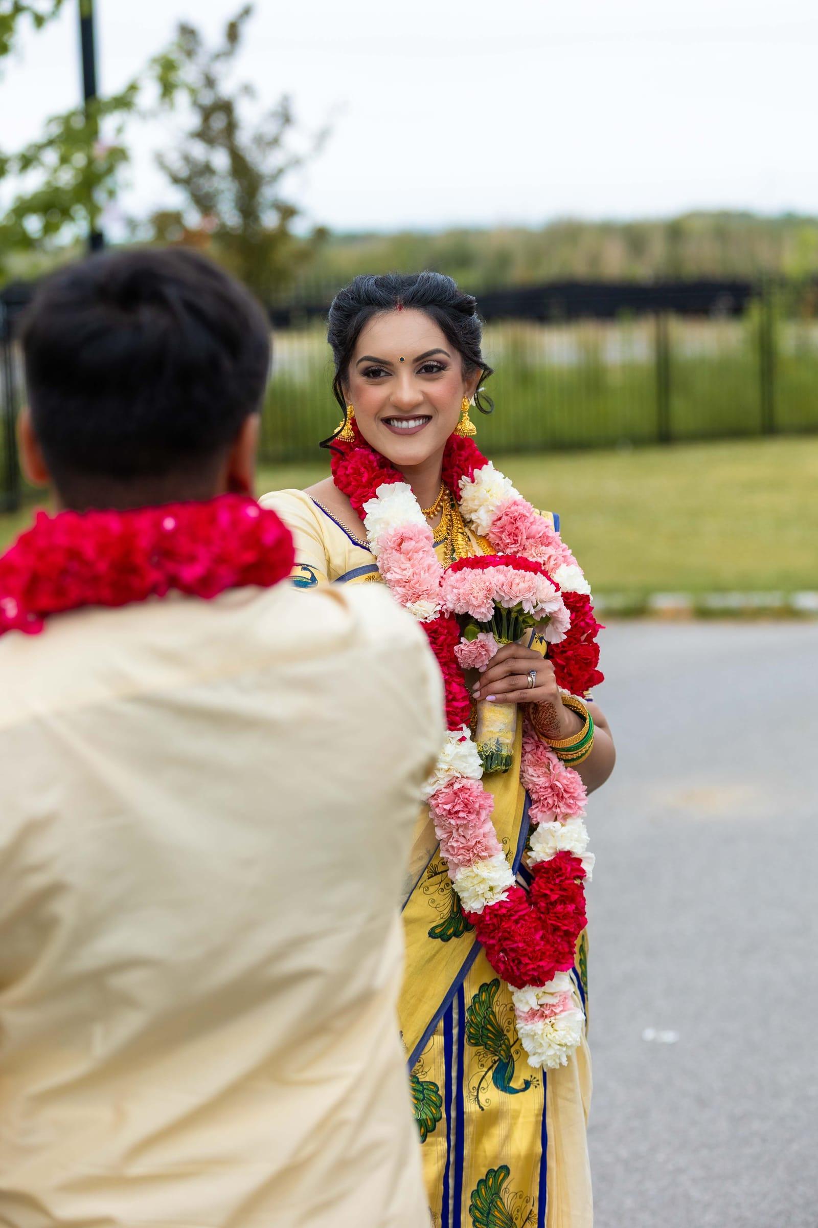 Smiling bride wearing a flower garland after the ceremony