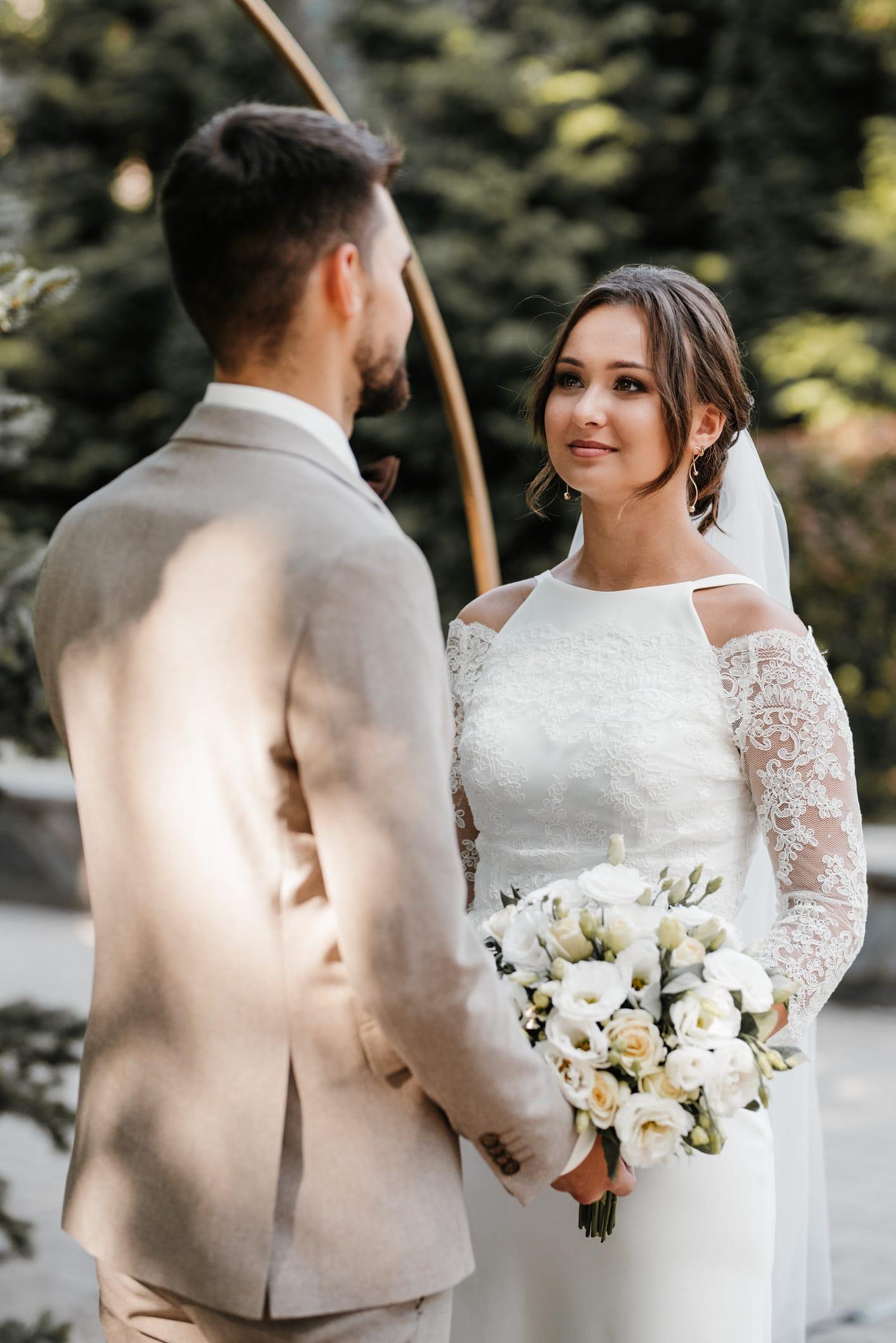 Bride and groom hold hands during an outdoor ceremony in the GTA