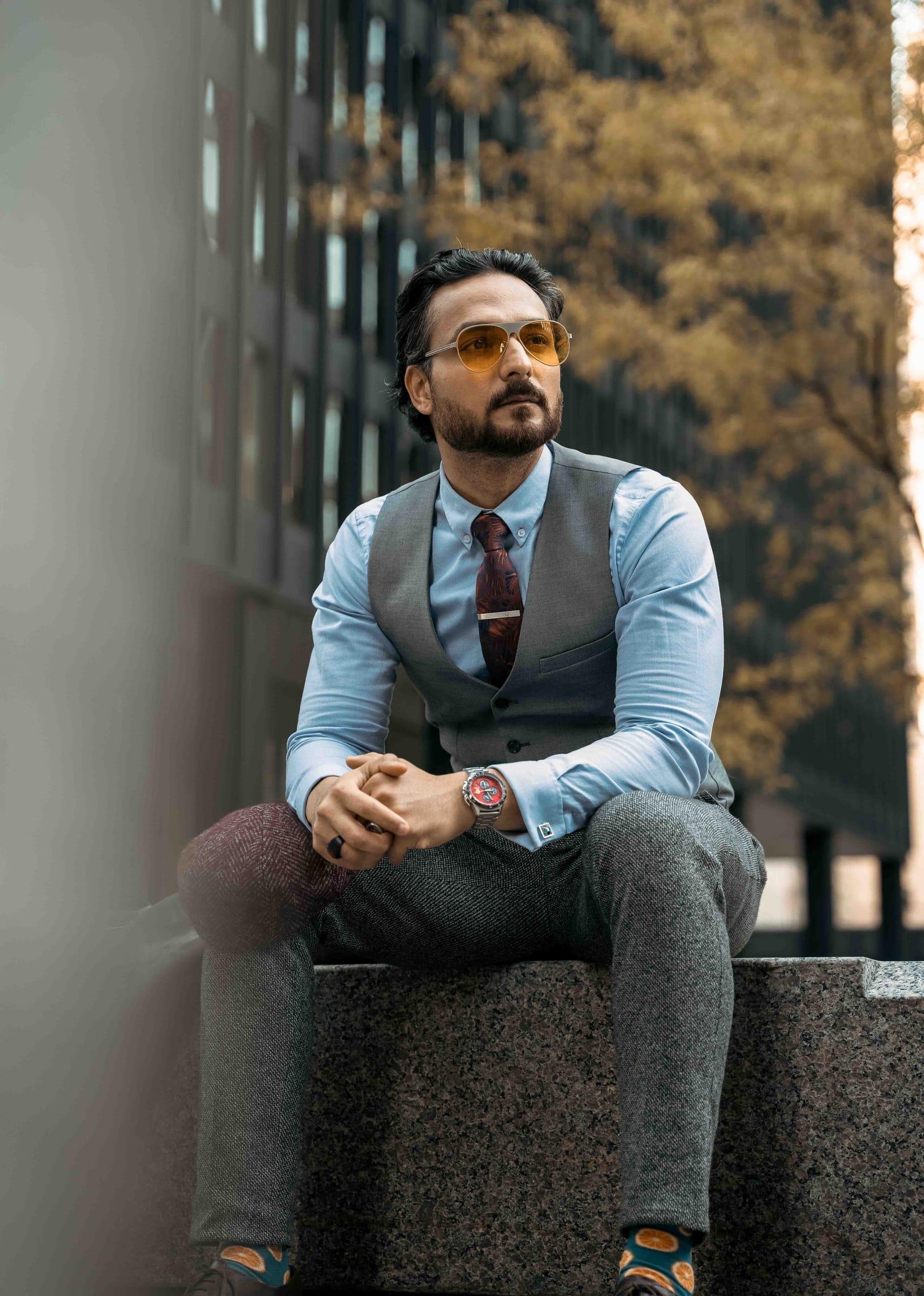 Stylish man seated on a ledge in a downtown Toronto street portrait