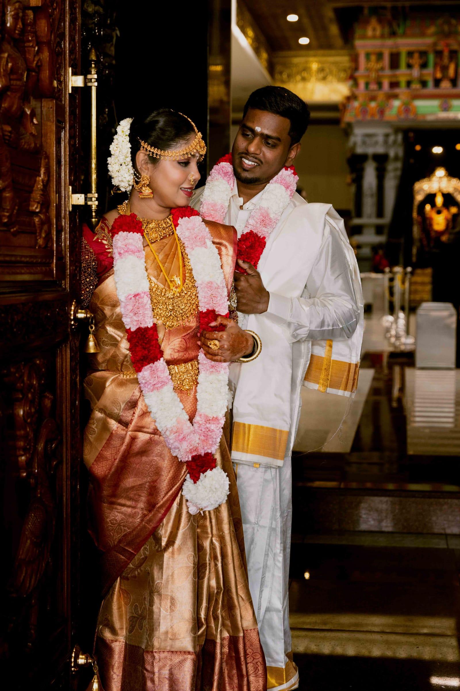 Tamil bride and groom with flower garlands at a Hindu temple wedding in Scarborough
